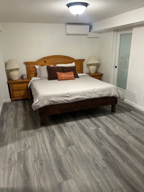 The Fairway Suite, a one-bedroom suite with a queen bed and wall-mounted air conditioning